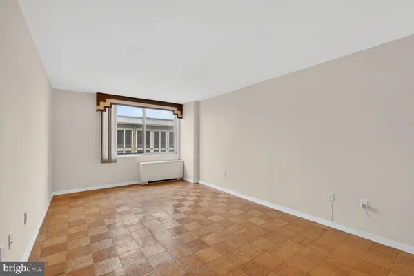 an empty room with windows and closet