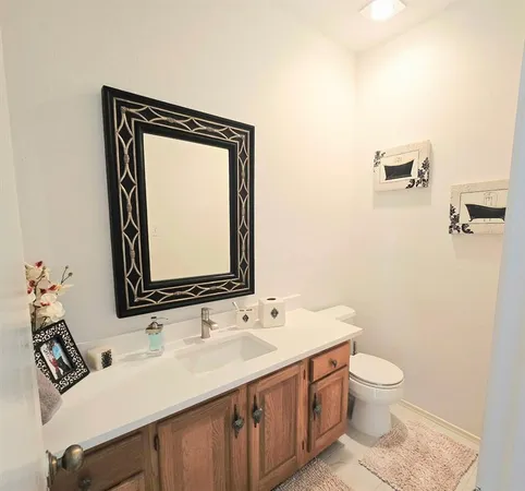 a bathroom with a toilet a sink and mirror