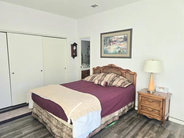 a bedroom with a bed and a lamp on table