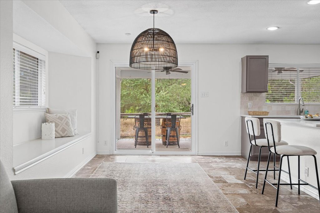 7451 Pusch Ridge Loop Austin, TX 78749 - Photo 8 of 26 Sliding glass doors open to the outdoors from this versatile tiled dining area.