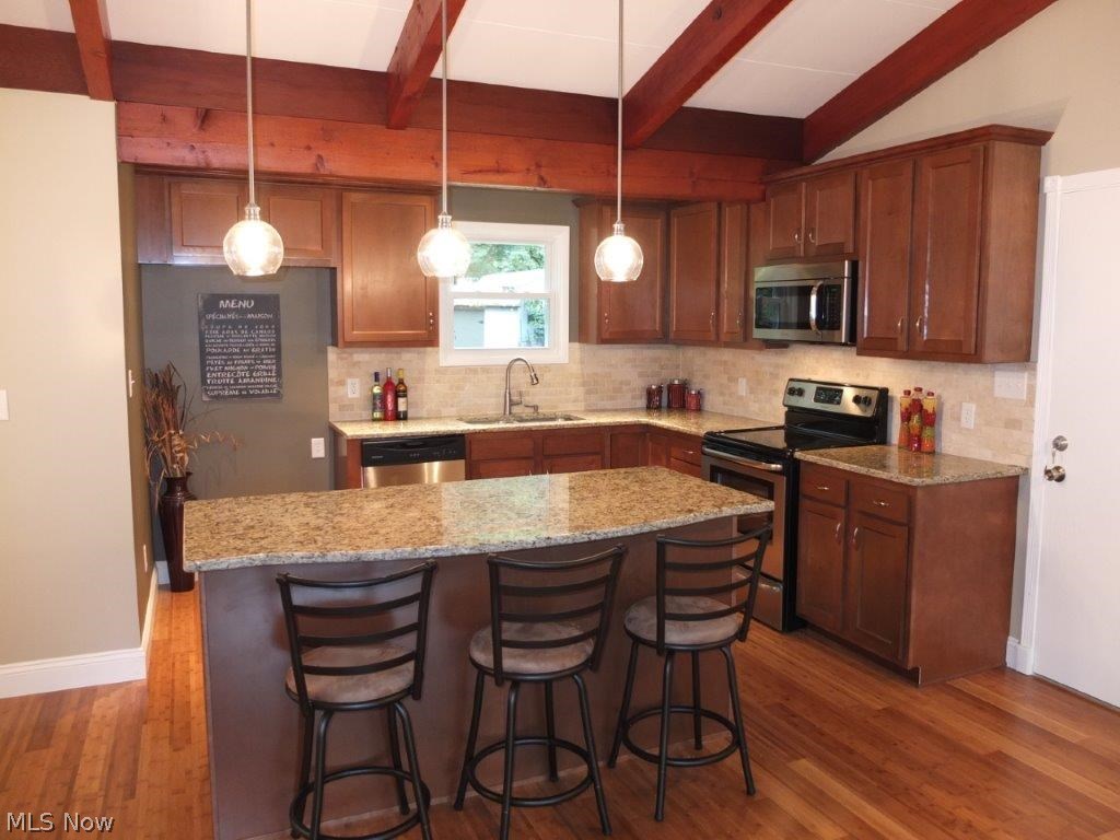4262 Springdale Road Uniontown, OH 44685 - Photo 4 of 20 Remodeled kitchen has granite countertops, tile backsplash, new cabinets and center island with breakfast bar.