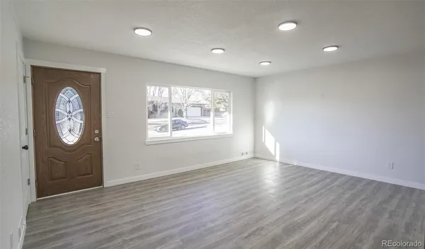 a bathroom with a granite countertop toilet sink and mirror
