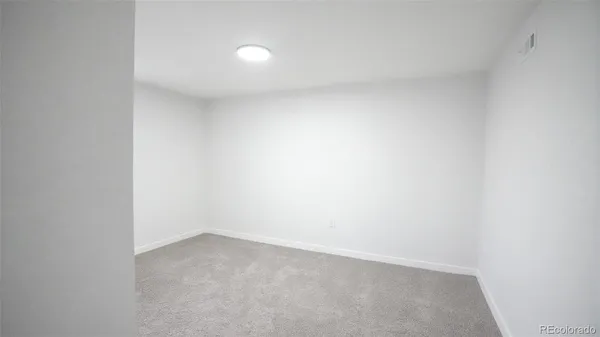 an empty room with closet area