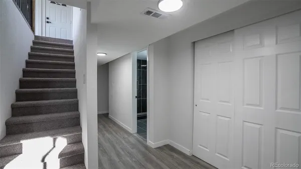 a bathroom with a toilet a sink a mirror and a shower