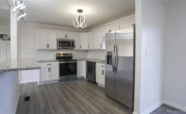 a kitchen with a refrigerator a stove top oven a sink and dishwasher
