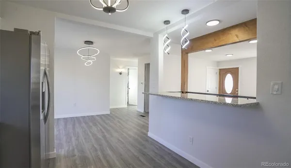 a view of a hallway with wooden floor