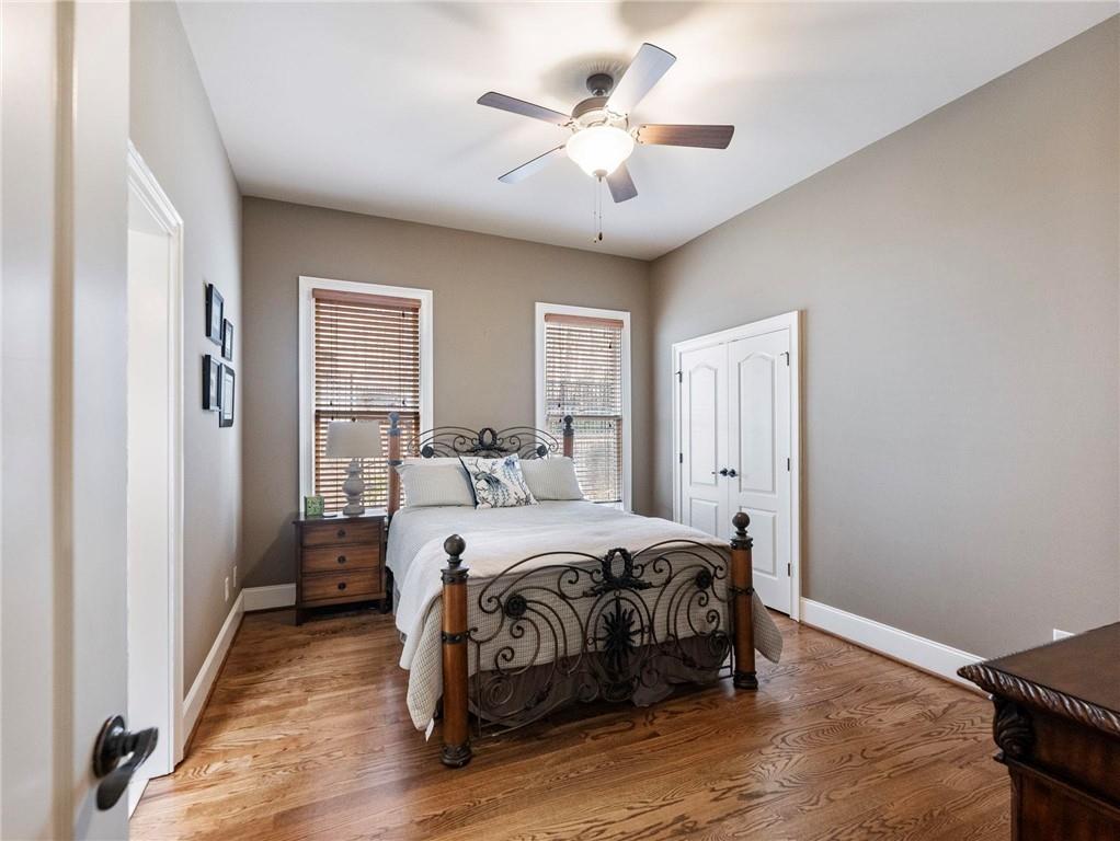 6147 Golf View Court Jefferson, GA 30549 - Photo 29 of 73 a bedroom with a bed and a ceiling fan