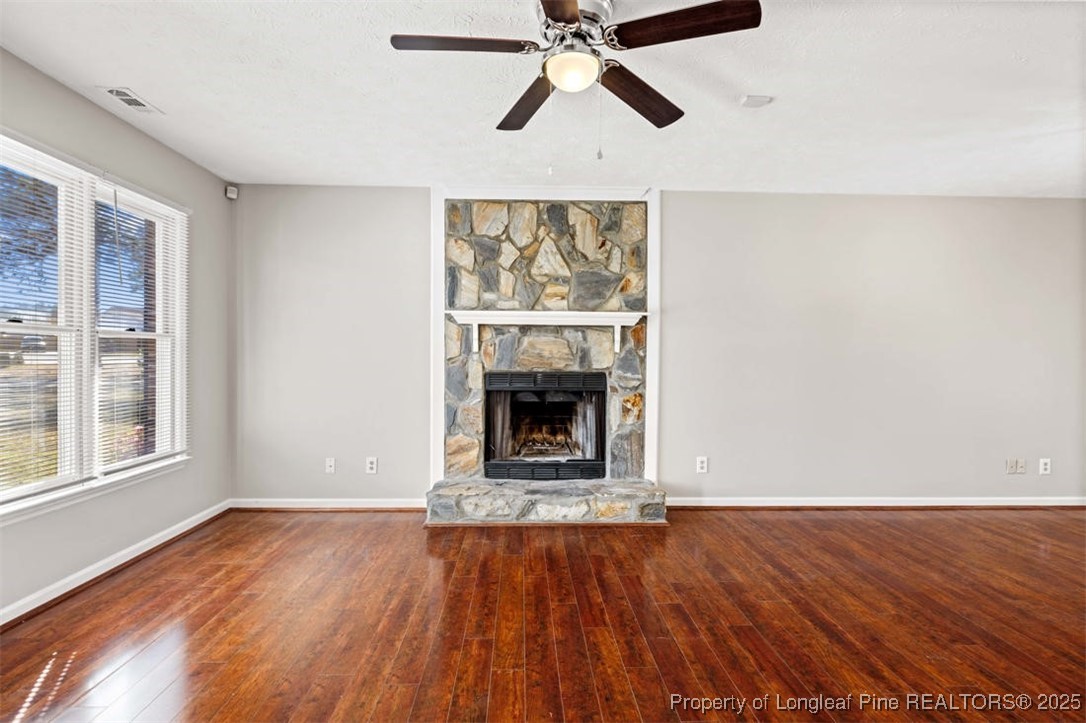 102 Ryans Circle Spring Lake, NC 28390 - Photo 11 of 26 a view of an empty room with wooden floor fireplace and a window