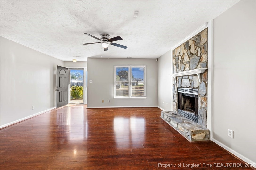 102 Ryans Circle Spring Lake, NC 28390 - Photo 12 of 26 a living room with wooden floors and a fireplace