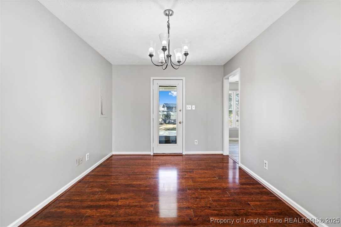 102 Ryans Circle Spring Lake, NC 28390 - Photo 13 of 26 a view of an empty room with window and wooden floor