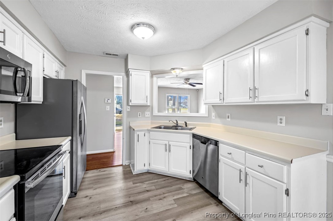 102 Ryans Circle Spring Lake, NC 28390 - Photo 14 of 26 a kitchen with stainless steel appliances granite countertop a refrigerator and a stove top oven