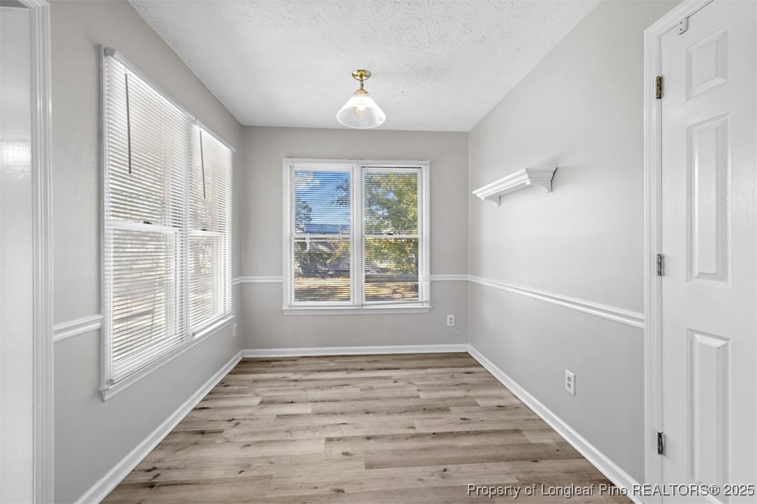 102 Ryans Circle Spring Lake, NC 28390 - Photo 16 of 26 a view of an empty room with wooden floor and a window