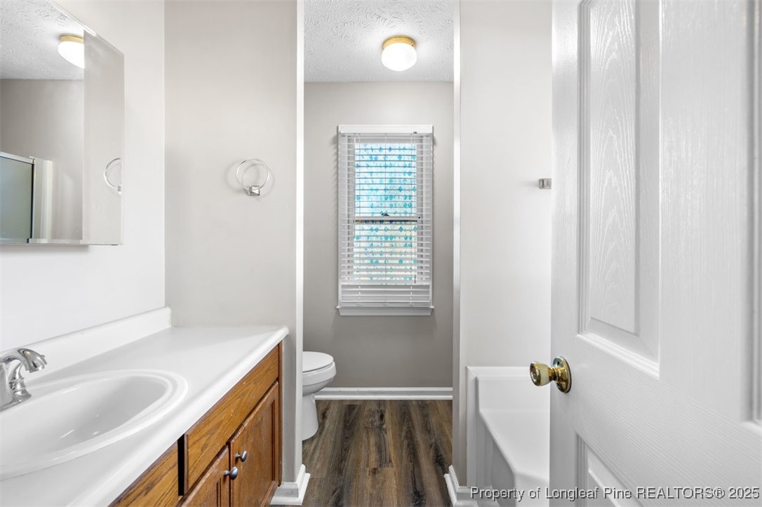 102 Ryans Circle Spring Lake, NC 28390 - Photo 21 of 26 a bathroom with a sink a toilet and shower