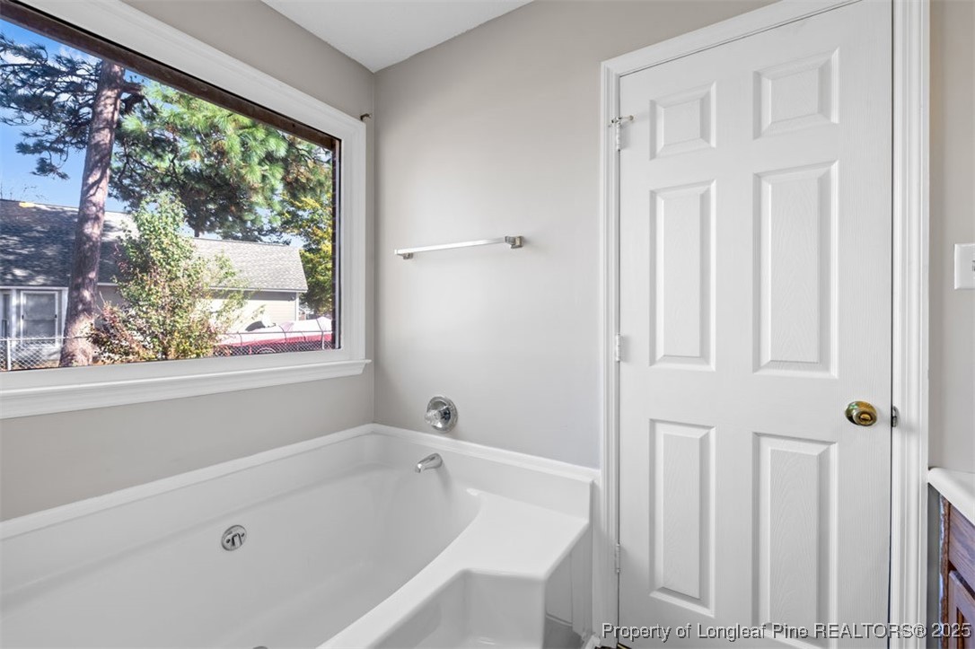 102 Ryans Circle Spring Lake, NC 28390 - Photo 22 of 26 a bathroom with a bathtub and shower