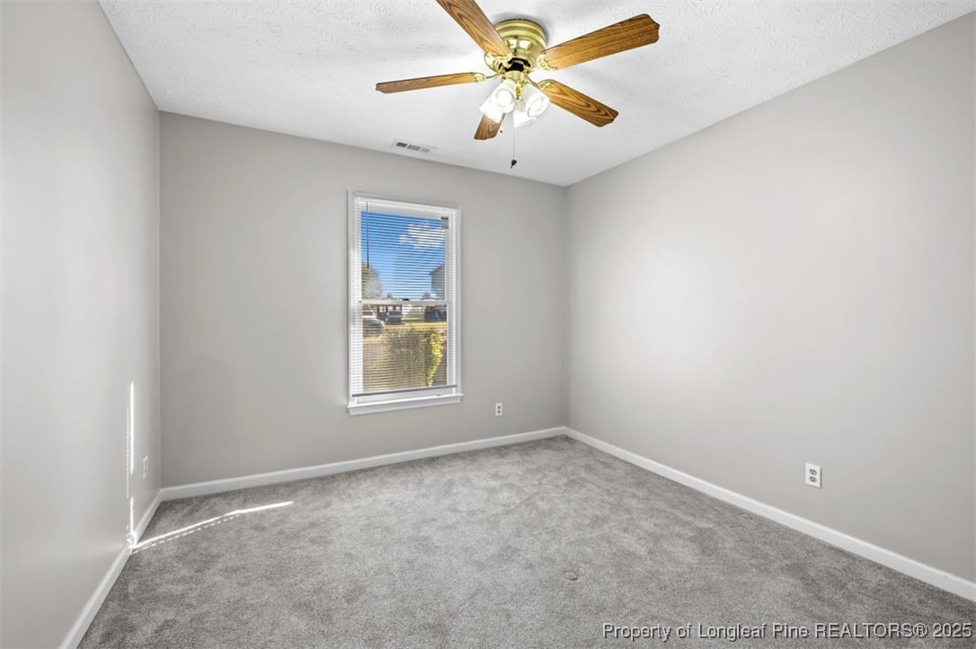 102 Ryans Circle Spring Lake, NC 28390 - Photo 25 of 26 an empty room with a window and a fan