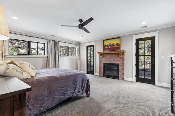 a spacious bedroom with a bed and a fireplace