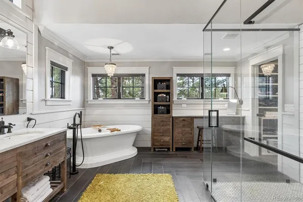 a bathroom with a tub sink and mirror