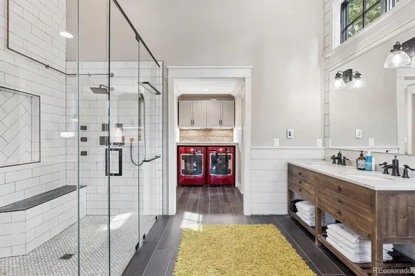 a bathroom with a tub sink shower and mirror