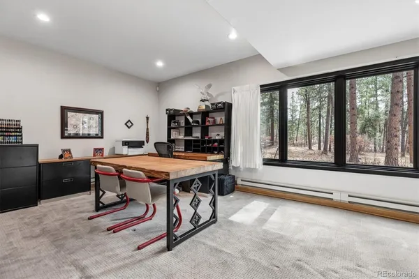 a dining room with a large window table and chairs