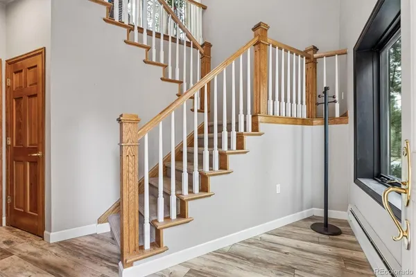a view of entryway and hall with wooden floor