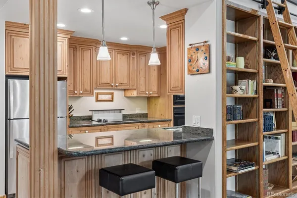 a kitchen with stainless steel appliances granite countertop a stove and a refrigerator