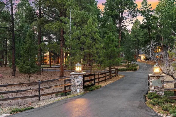 a view of a bench with wooden fence