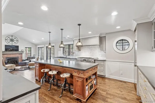 a kitchen with stainless steel appliances granite countertop a sink and a stove top oven
