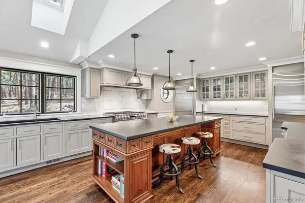 a kitchen with stainless steel appliances granite countertop a stove and a sink