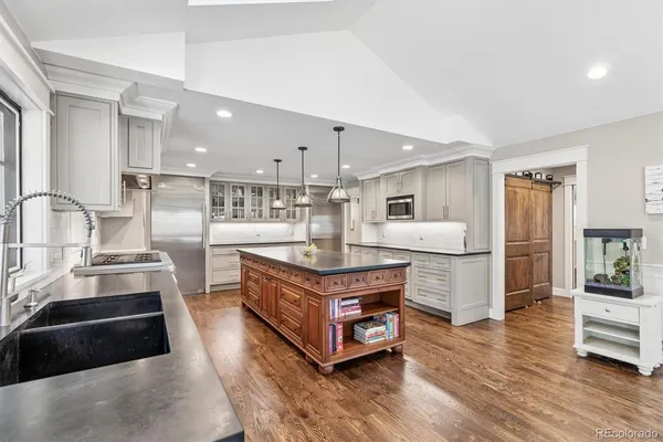 a kitchen with stainless steel appliances granite countertop a stove and a refrigerator