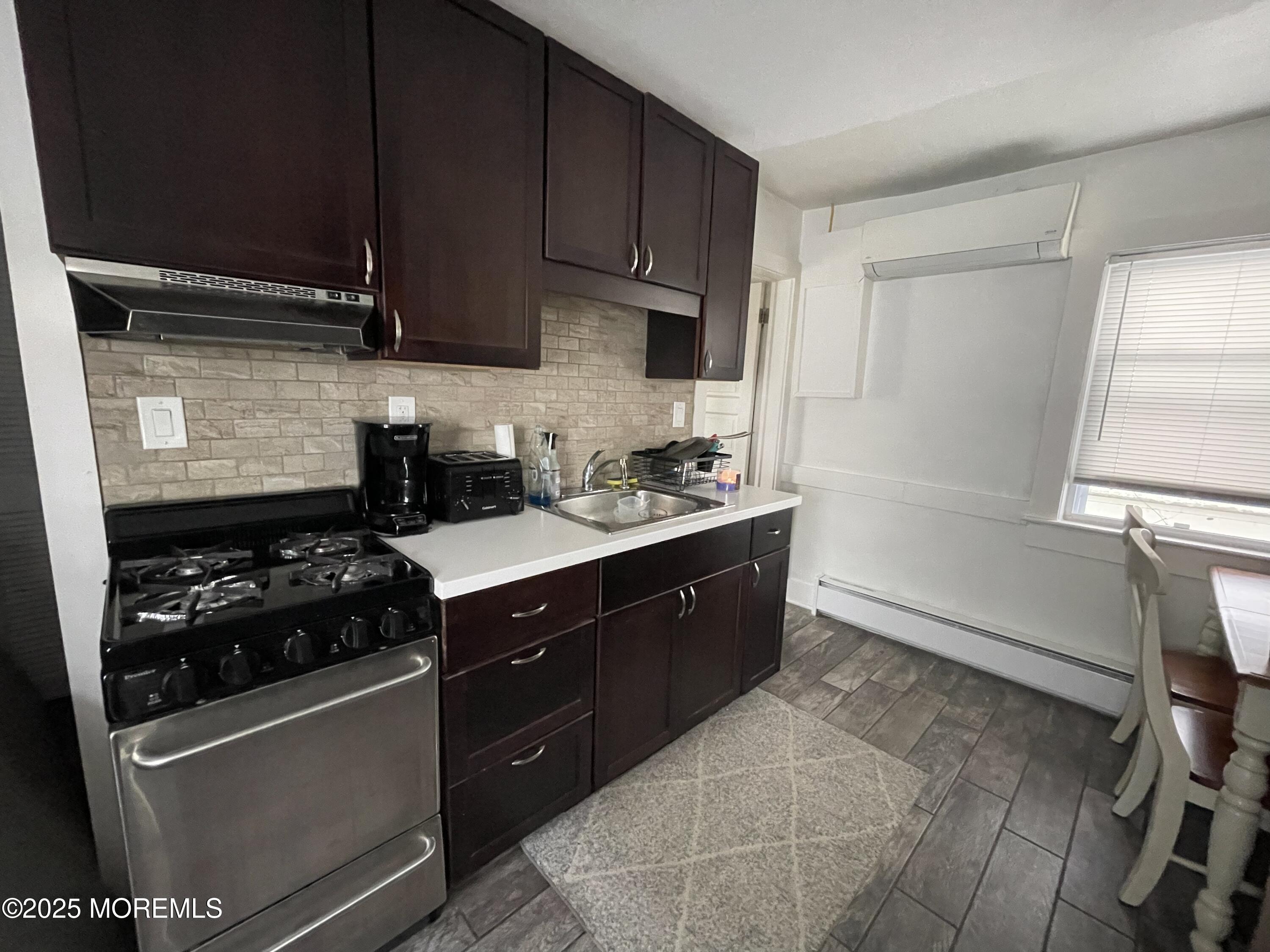 94.5 Poplar Avenue Deal, NJ 07723 - Photo 3 of 3 a kitchen with a sink a stove and cabinets