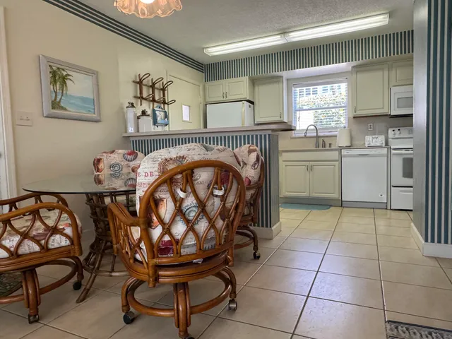 a view of a balcony with chairs and wooden floor