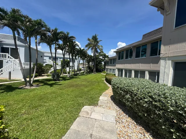 a swimming pool with outdoor seating and yard