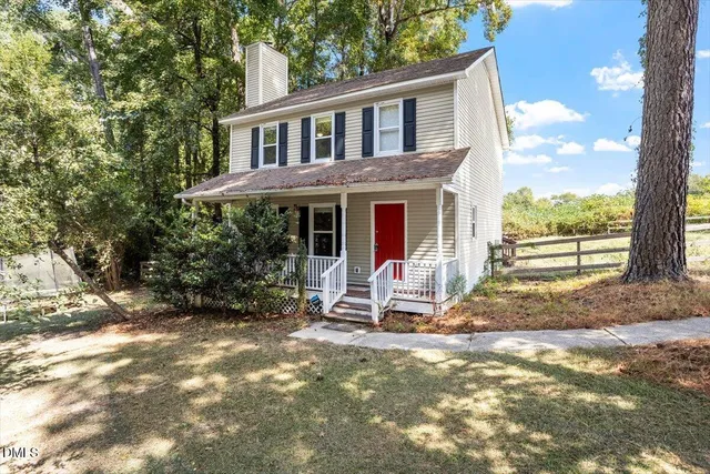 a view of a house with backyard porch and sitting area