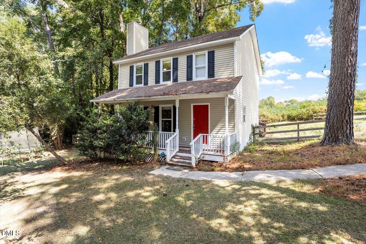 a view of a house with backyard porch and sitting area