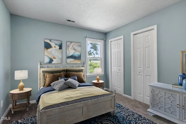 a bedroom with a bed and large window