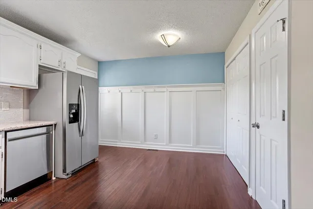 a view of a kitchen with a refrigerator a stove top oven