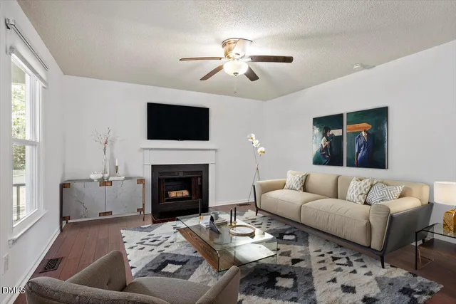 a living room with furniture a fireplace and a flat screen tv