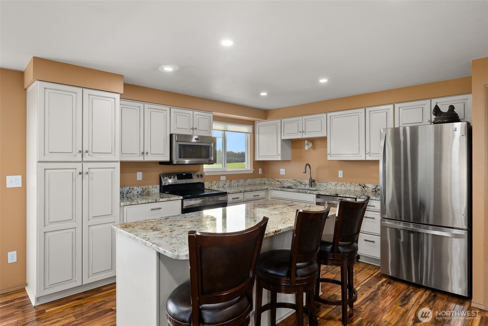 198 Short Road Onalaska, WA 98570 - Photo 13 of 40 a kitchen with stainless steel appliances granite countertop a refrigerator a stove a sink a dining table and chairs