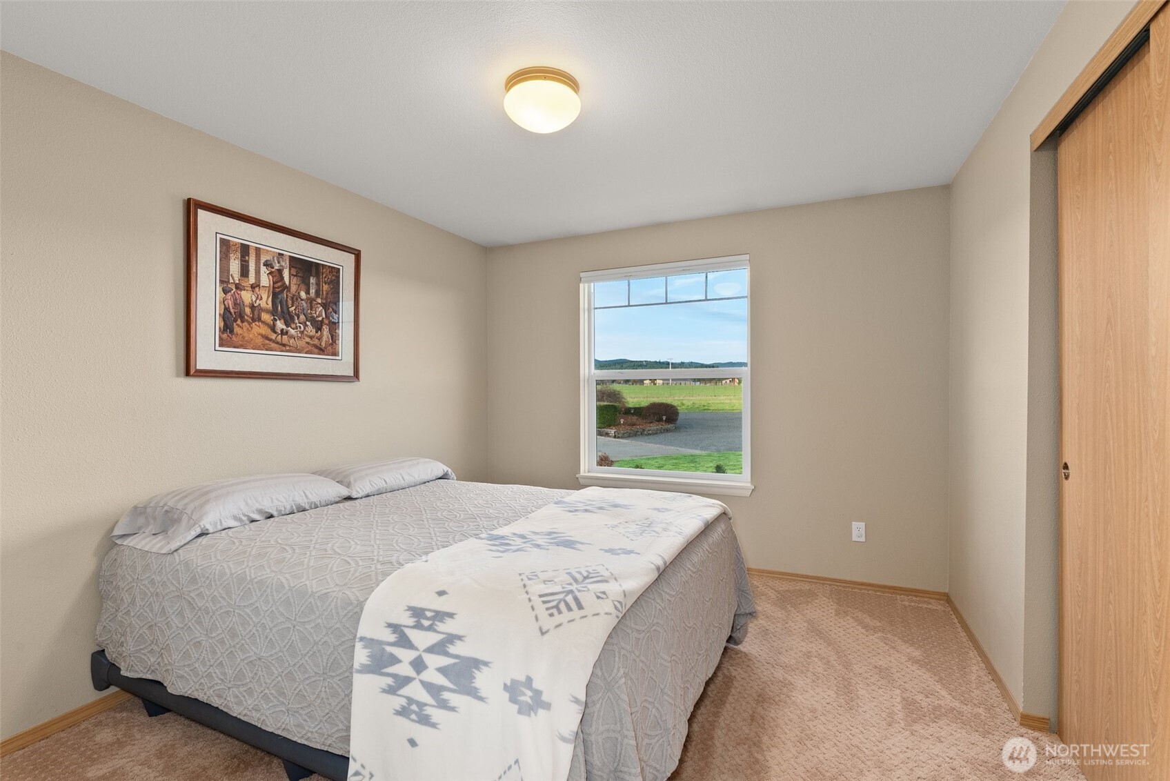198 Short Road Onalaska, WA 98570 - Photo 19 of 40 a spacious bedroom with a bed and a window
