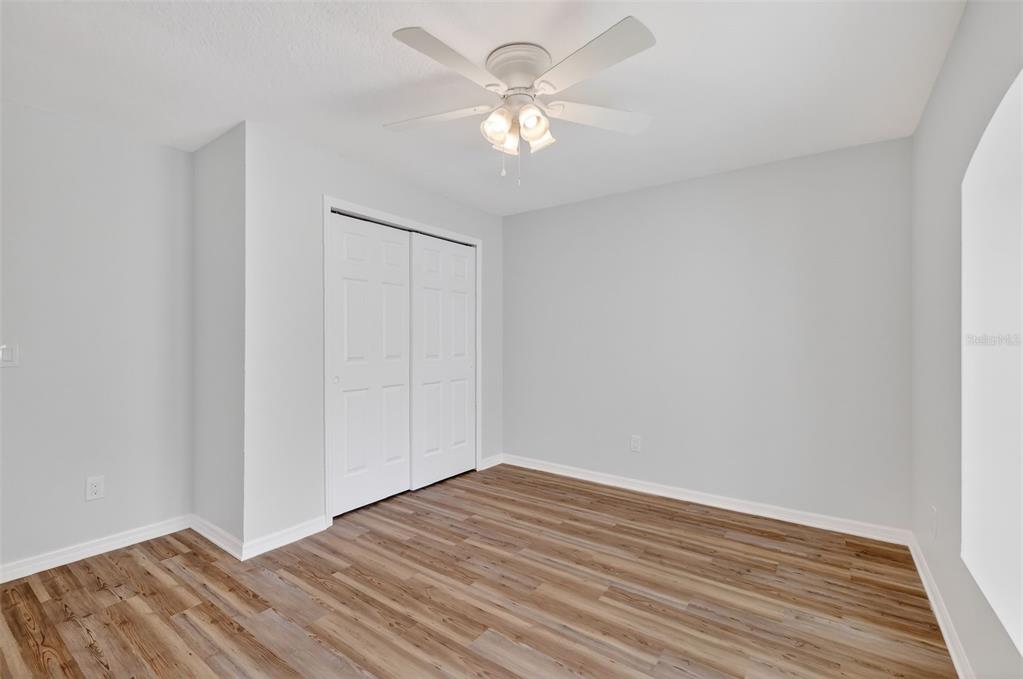 6027 Spring Creek Court Mount Dora, FL 32757 - Photo 23 of 42 a view of an empty room with wooden floor