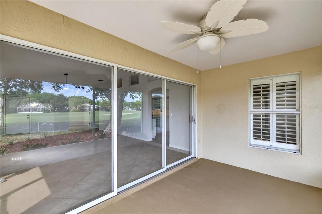 6027 Spring Creek Court Mount Dora, FL 32757 - Photo 26 of 42 a view of a hallway with a chandelier fan and windows