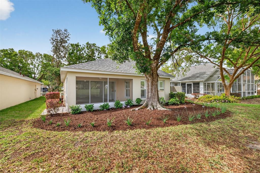 6027 Spring Creek Court Mount Dora, FL 32757 - Photo 34 of 42 a front view of a house with garden