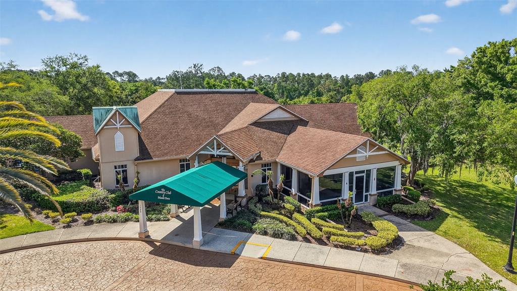 6027 Spring Creek Court Mount Dora, FL 32757 - Photo 40 of 42 an aerial view of a house with garden space and street view