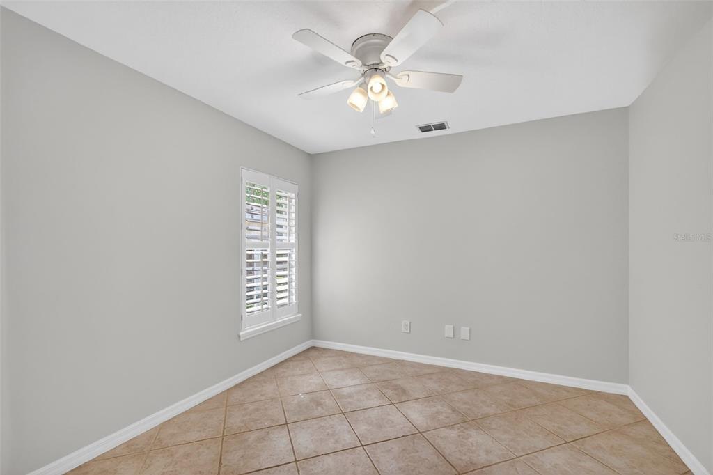 6027 Spring Creek Court Mount Dora, FL 32757 - Photo 8 of 42 an empty room with windows and fan