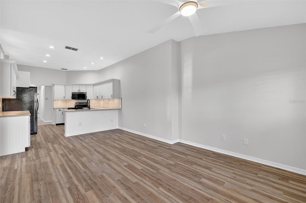 6027 Spring Creek Court Mount Dora, FL 32757 - Photo 10 of 42 a view of kitchen with wooden floor and window