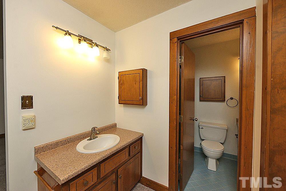 10205 Roadstead Way West Raleigh, NC 27613 - Photo 13 of 22 a bathroom with a granite countertop sink toilet and shower