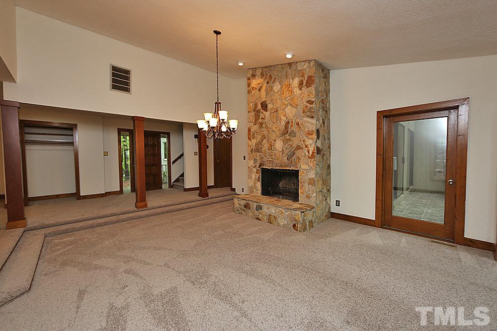 10205 Roadstead Way West Raleigh, NC 27613 - Photo 3 of 22 a view of a livingroom with an empty space and a fireplace