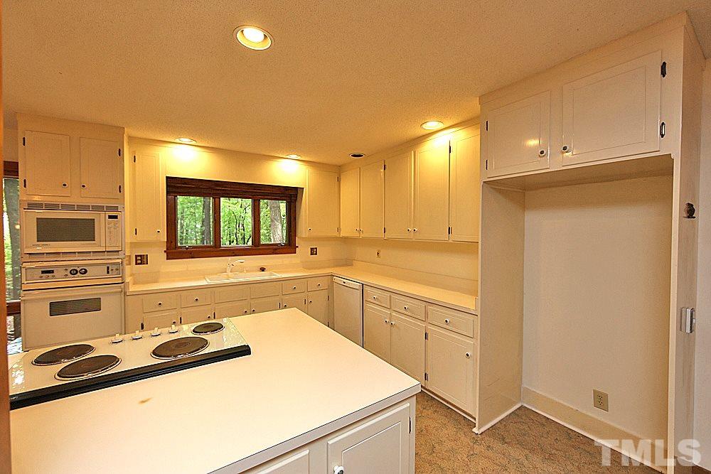 10205 Roadstead Way West Raleigh, NC 27613 - Photo 6 of 22 a kitchen with a sink stove and microwave