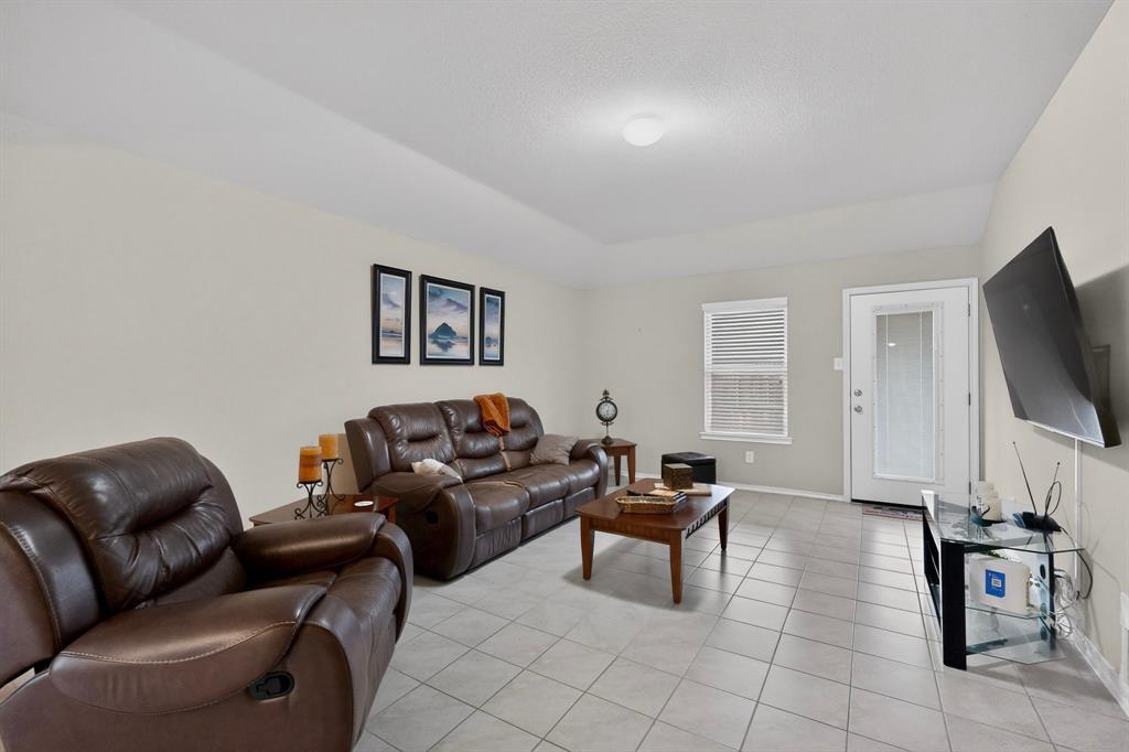 1409 Slate Street Princeton, TX 75407 - Photo 5 of 36 Spacious living area featuring light neutral walls and large format tile flooring