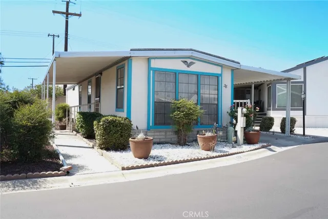 a view of a house with potted plants